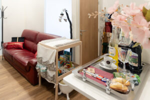 Espace cocooning du studio photo équipé pour accueillir les familles, femme enceinte, nouveau né, bébé, enfants avec canapé, fauteuil, table à langer, et cet espace détente dans la salle de shooting du studio photo
